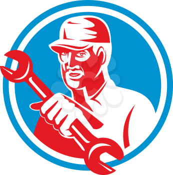 Illustration of a mechanic holding spanner wrench facing front set inside circle on isolated background done in retro style. 