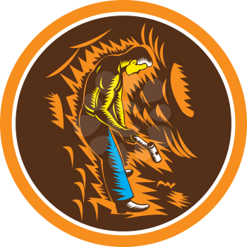 Illustration of a coal miner holding sledgehammer working viewed from the side set inside circle done in retro woodcut style.