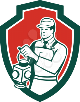 Illustration of a train railway signaller signalman holding lamp set inside shield crest on isolated background done in retro style. 