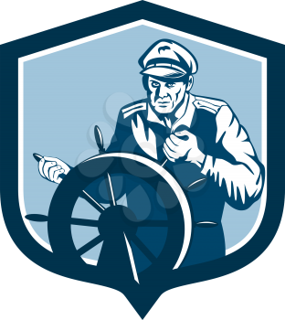 Illustration of a fisherman sea captain at the wheel helm facing front set inside shield crest on isolated background done in retro style.
