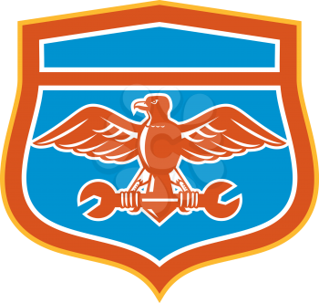 Illustration of a bald eagle flying holding spanner looking to the side set inside shield crest on isolated background done in retro style.