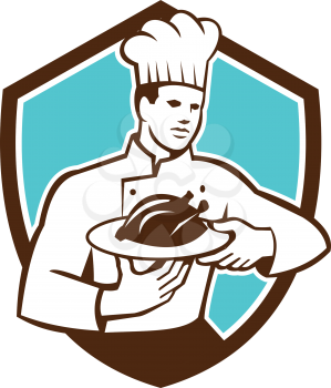 Illustration of a chef cook holding serving serve plate platter with chicken set inside shield crest on isolated background done in retro style. 