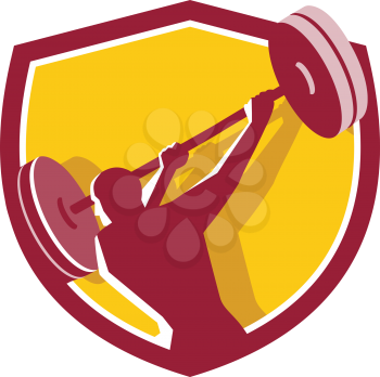 Illustration of a weightlifter lifting swinging barbell looking to the side viewed from rear set inside shield crest on isolated background done in retro style.