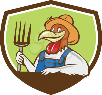Illustration of a chicken farmer wearing overalls and hat holding pitchfork  viewed from front set inside shield crest on isolated background done in cartoon style. 