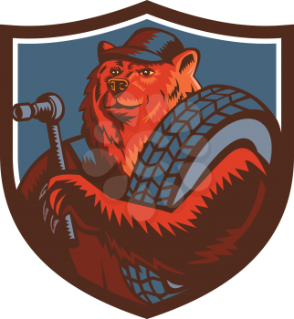 Mascot icon illustration of a Russian bear who is a tireman holding a tire and socket wrench set inside crest shield viewed from front on isolated background in retro style.