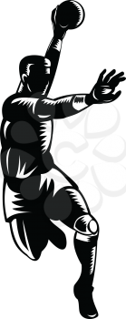 Retro woodcut style illustration of a European handball player, also known as team handball, with ball jumping scoring on isolated background done in black and white.