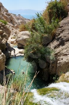 Royalty Free Photo of a Small Waterfall Down Rocks Into a Stream