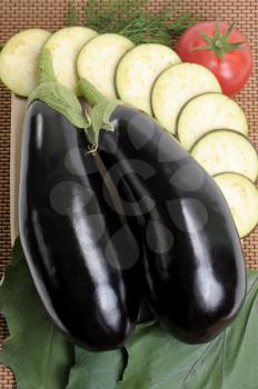 Royalty Free Photo of Eggplants, Slices and a Tomato