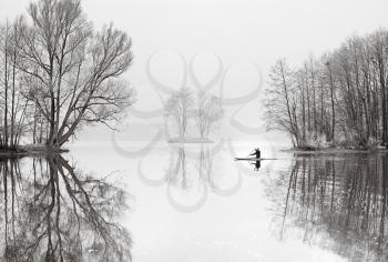 Royalty Free Photo of a Man on a Lake in a Boat