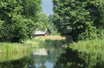 Royalty Free Photo of a Small Building in a Bush