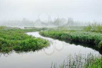 The sunrise, over the river rises a morning fog.