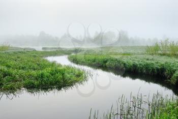 The sunrise, over the river rises a morning fog.