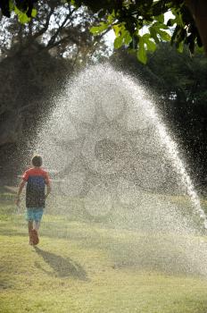 Children play with jets of water in hot weather