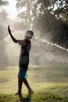 Children play with jets of water in hot weather
