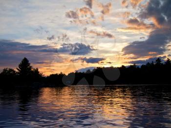 Royalty Free Photo of a Sunset With Water and Trees