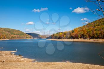 Royalty Free Photo of a Placid River Surrounded by Mountains in Autumn