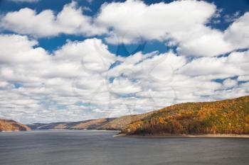 Royalty Free Photo of a River Surrounded by Mountain Forests in Autumn