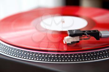 Vintage Record Turntable Plays Red Vinyl Disk Angled View