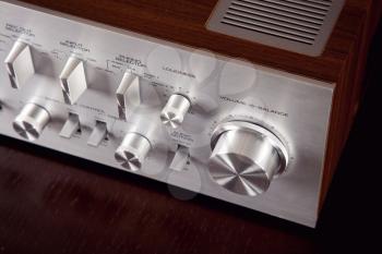 Vintage Stereo Amplifier Metal Frontal Panel Volume Control Knob Angled View Closeup