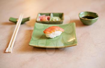 japanese sushi on the green plate and chopsticks