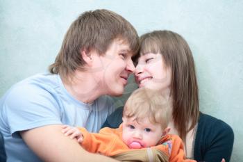 Excited happy young family of three person