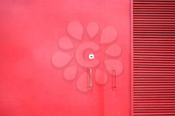 metal door of the red color with keyhole and handles