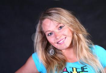 teenage blond girl portrait, studio shot on dark