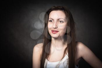 Portrait of a young brunette lady on white background