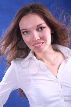 Intelligent looking female. This picture is taken in a studio on blue