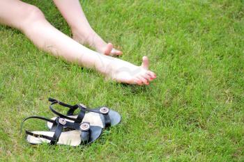 Perfect Feet in the sun with shaved legs on a meadow of a young sexy woman or girl