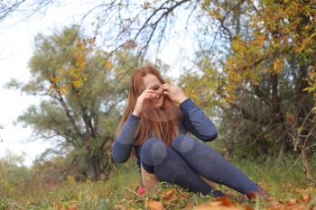 Beautiful girl relaxing in a magic autumn garden
