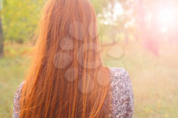 redhead from back backlit head and shoulders