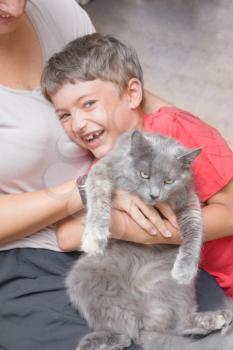 mother and son with cat having fun indoors