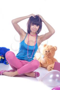 Young woman with toys in studio on white.