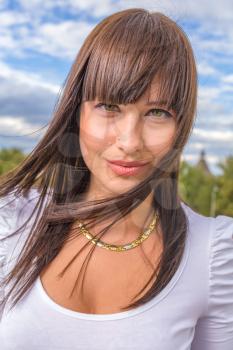 Outdoors street portrait of beautiful young brunette girl