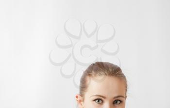 Half woman face with copy-space on side. Beautiful caucasian woman portrait on white background. Skincare beauty treatment concept. Close up of female eyes looking at camera - over a white background