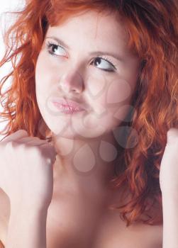 Redhead with fist on white closeup