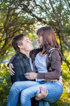 Happy young couple. Holding women on the hands and fav fun a lot of positive emotions