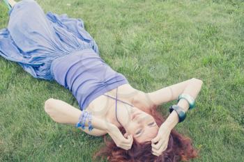 redhead 20s women laying down in the grass