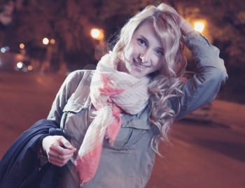 Portrait of a young female businesswoman in night city. Close-up, shallow DOF.