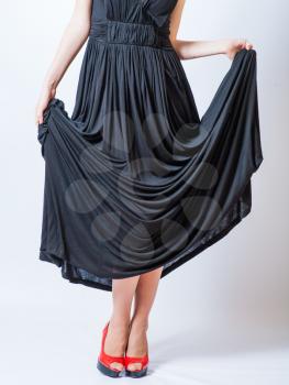 redhead waist down body in black dress,studio shot
