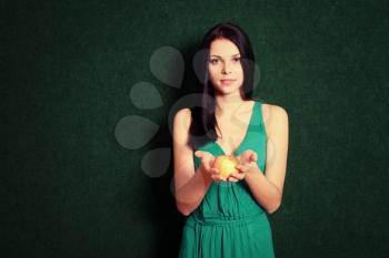 women with apple on green background, color corrected image