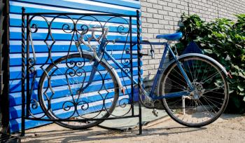 City bicycle fixed gear and blue wall, vintage bike. Retro stylish cycling in town.