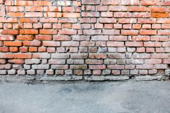Red brick wall and a blacktop for copyspace backgrounds.