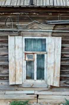 Hut (shantie) window front view. Vintage window of a aged  wooden house in Russia.