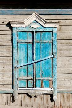 Aged wood window painted in blue colour