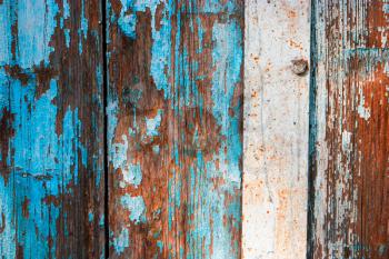 Weathered wood planks half painted in blue