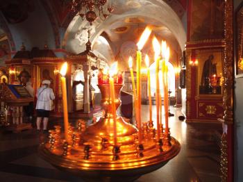 Astrakhan Russia - 10 October 2020: Orthodox chirch inside view with burning candles on foreground, city of Astrakhan, Russia