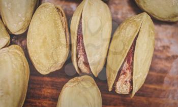 Macro Shot of Pistachio Nuts on hardwood Background.
