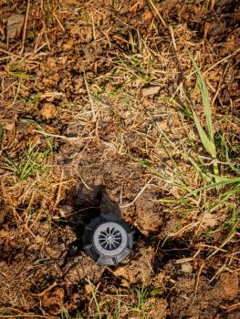 Top view of a sprinkler for water irrigation in garden soil in spring